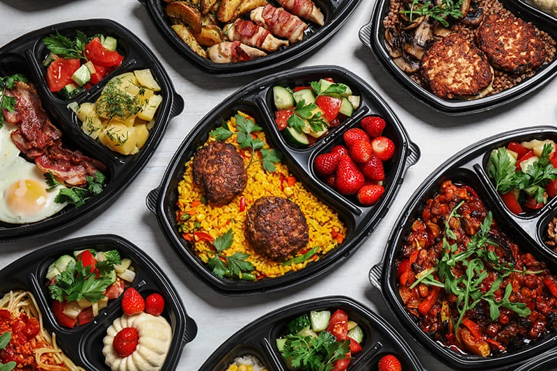 blog diverse meals in black takeout containers
